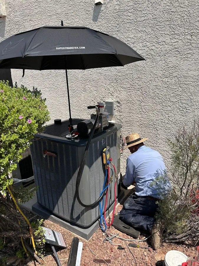 HVAC technician performing outdoor AC maintenance in Madera Acres